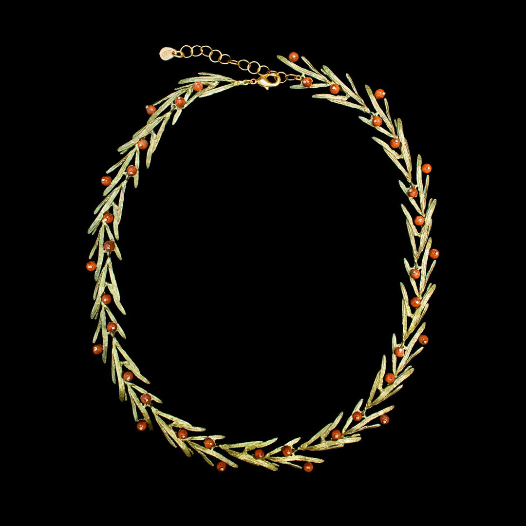 A green-toned necklace featuring a wreath design made of olive-green leaves and small orange-red berries, displayed against a solid black background.