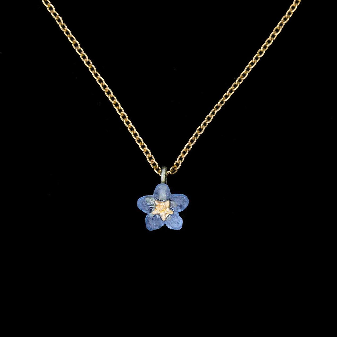 Necklace with a blue flower pendant on a black background