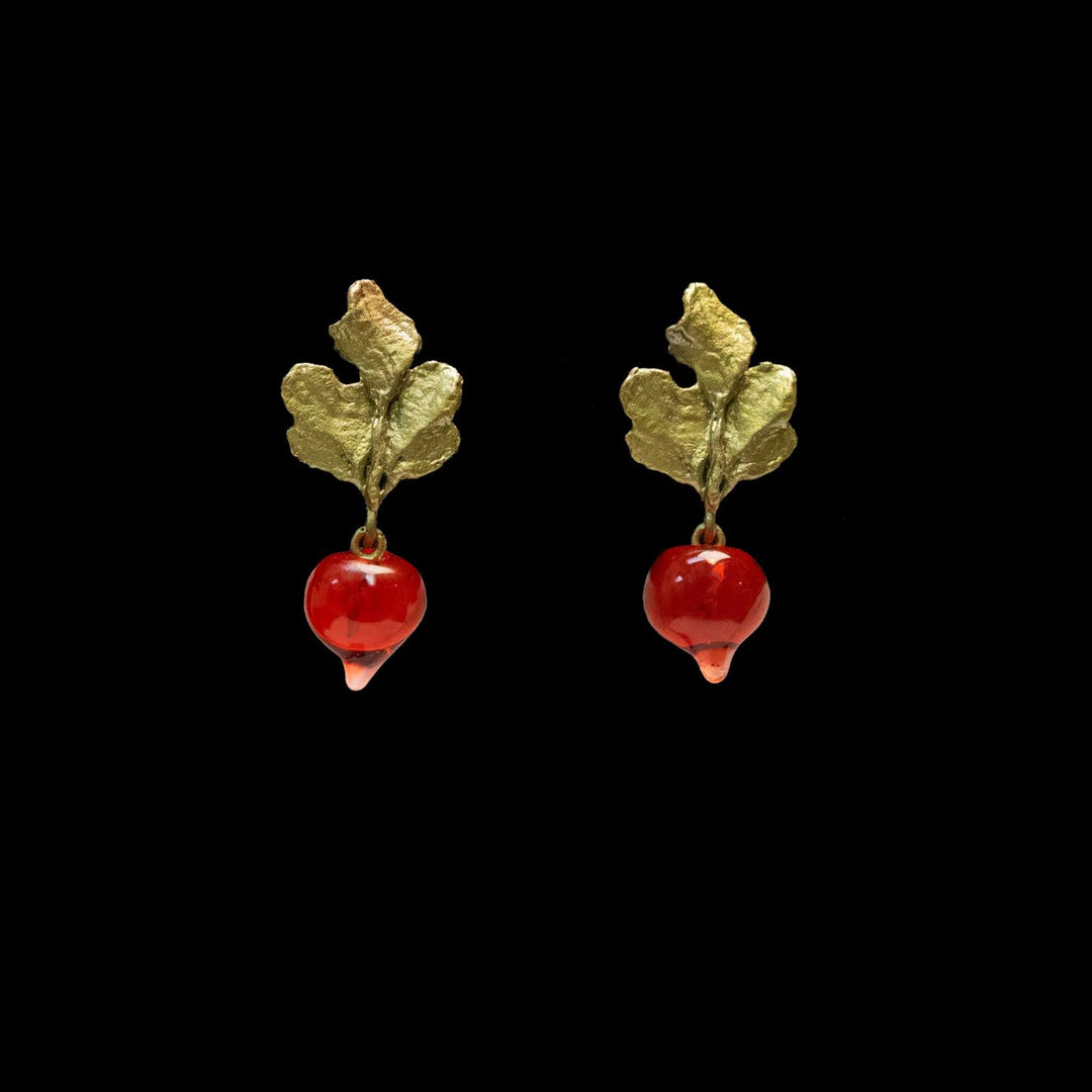 A pair of green leaf and radish-shaped earrings with glossy red glass radish, shown against a solid black background.
