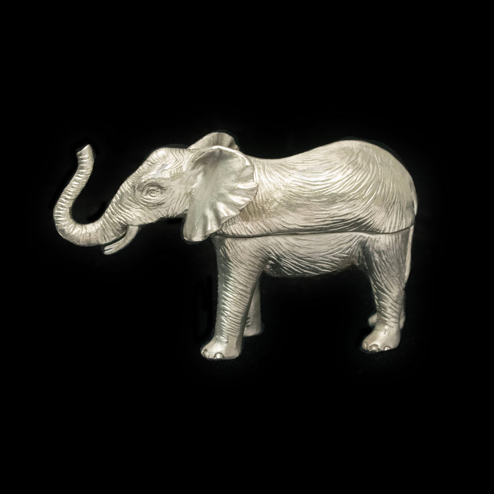Silver elephant figurine on a black background